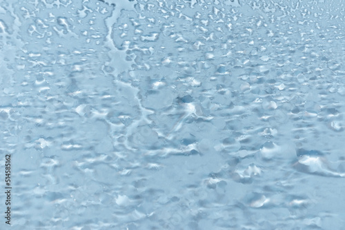 Water drops condensate on white background texture on transparent glass. backdrop glass covered with abstract drops of water.blurred image.