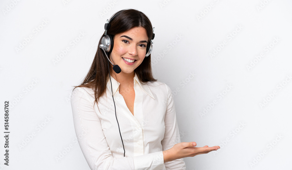 Telemarketer caucasian woman working with a headset isolated on white background presenting an idea while looking smiling towards Telemarketer caucasian woman working with a headset isolated on white background presenting an idea while looking smiling towards