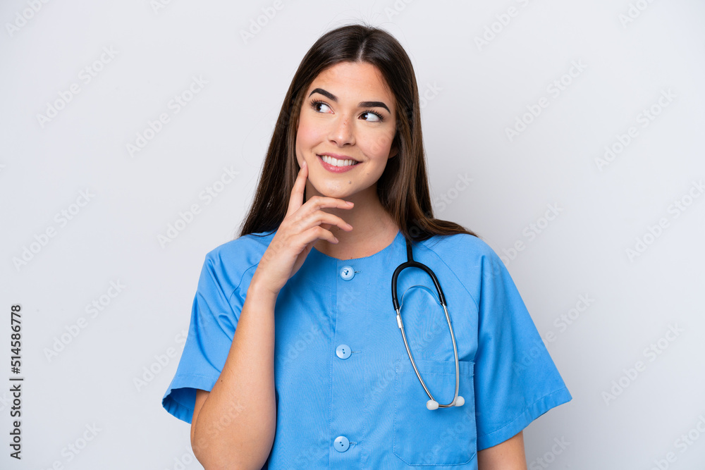 Young Brazilian nurse woman isolated on white background thinking an idea while looking up Young Brazilian nurse woman isolated on white background thinking an idea while looking up