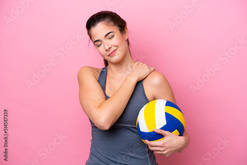 Young Brazilian woman playing volleyball isolated on pink background suffering from pain in shoulder for having made an effort