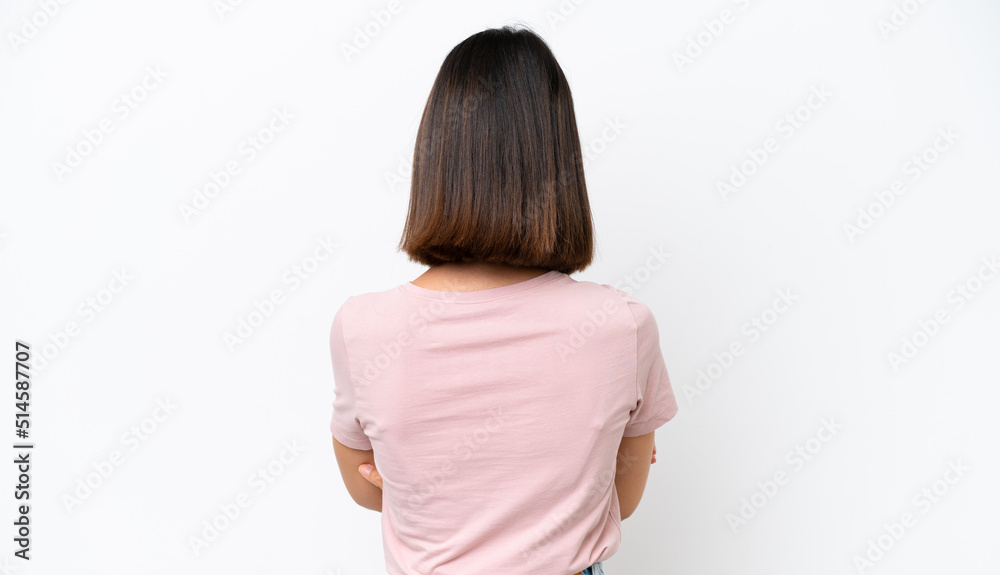 Young caucasian woman isolated on white background in back position Young caucasian woman isolated on white background in back position