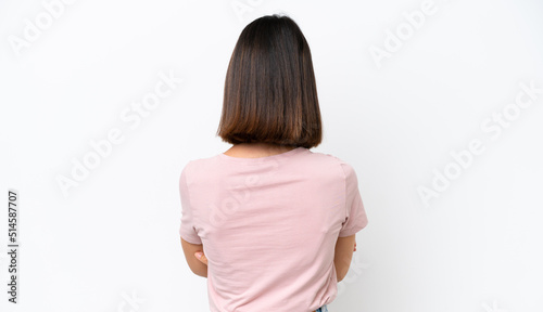 Young caucasian woman isolated on white background in back position