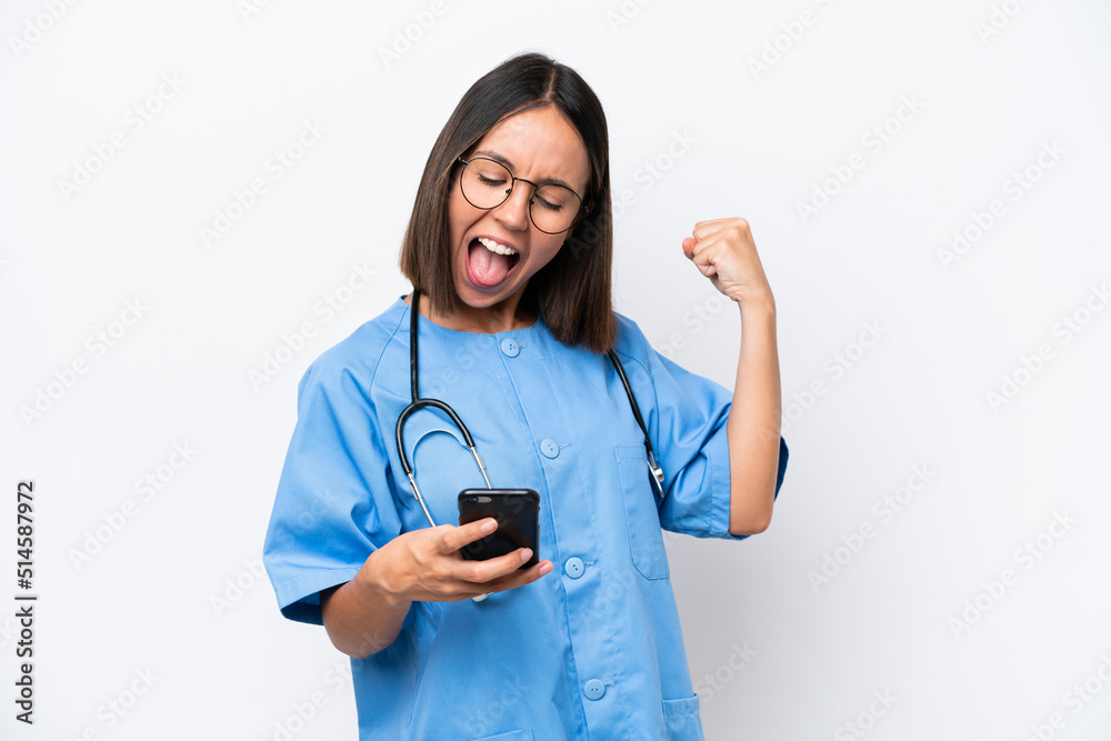 Young surgeon doctor woman isolated on white background surprised and sending a message Young surgeon doctor woman isolated on white background surprised and sending a message
