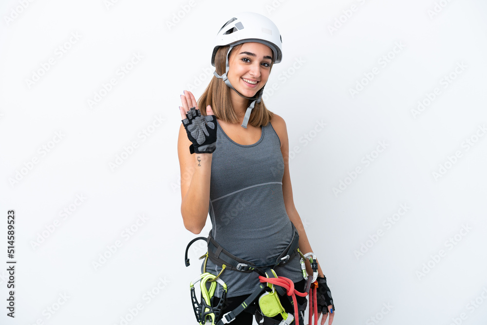 Young rock-climber woman isolated on white background saluting with hand with happy expression Young rock-climber woman isolated on white background saluting with hand with happy expression