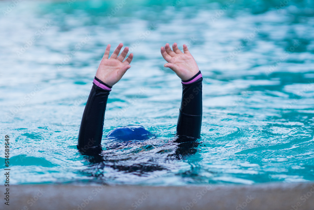 child in danger drowning in the pool, kid girl cannot swim to deep
