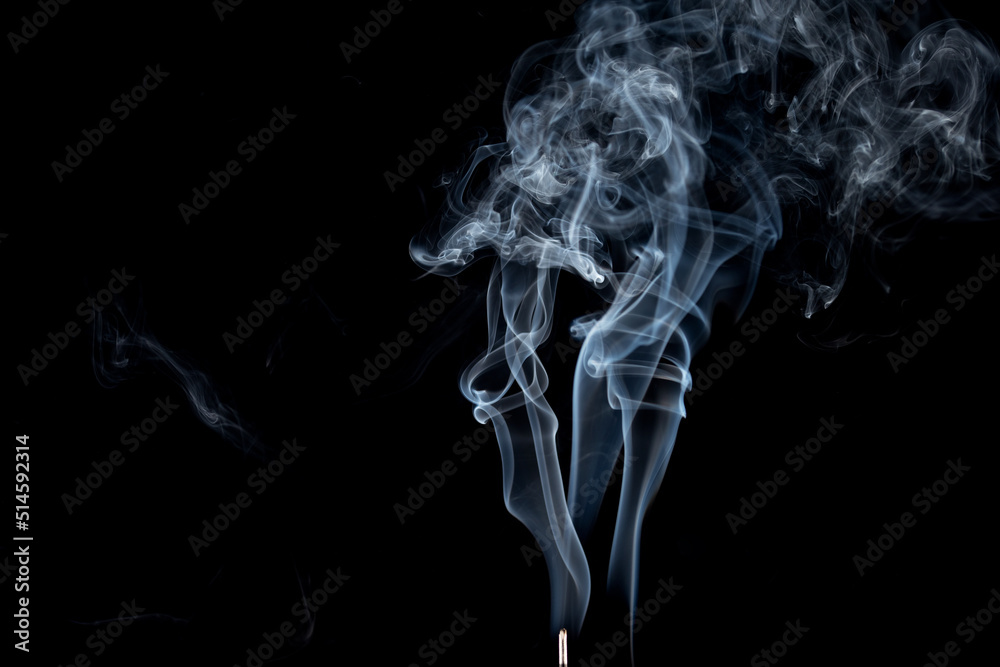 incense stick with smoke against black background incense stick with smoke against black background