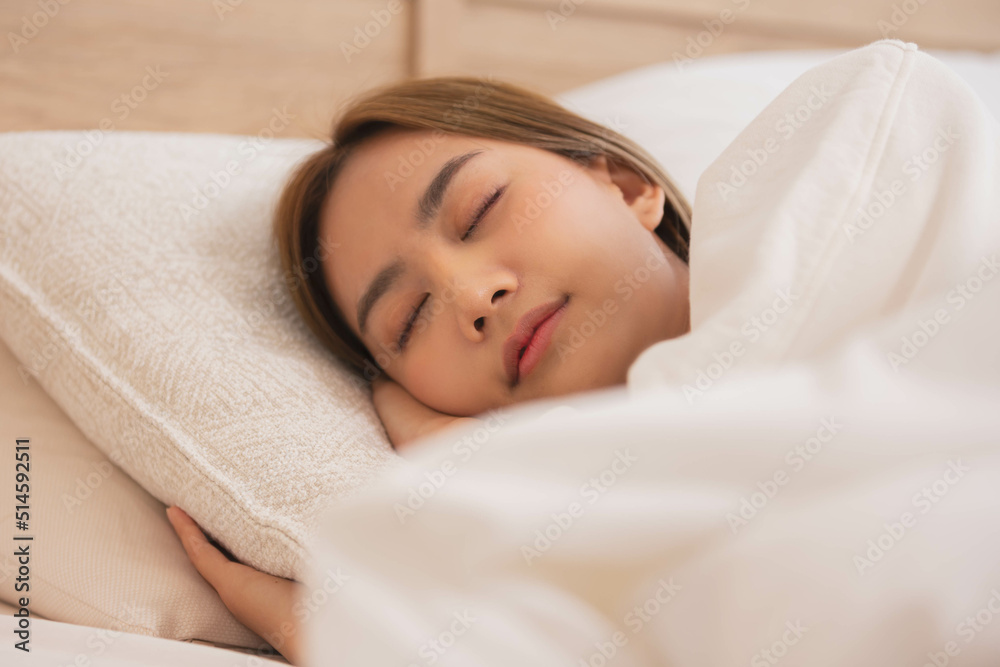 Asian women sleeping and sweet dream on white bed in bedroom Asian women sleeping and sweet dream on white bed in bedroom