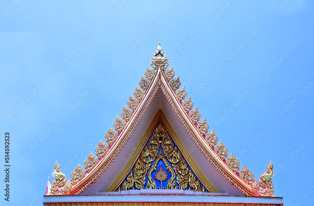 Naklejka premium Part of the Roof of a temple in Thailand. Traditional Thai style pattern on the roof of a temple with Blue Sky Background.