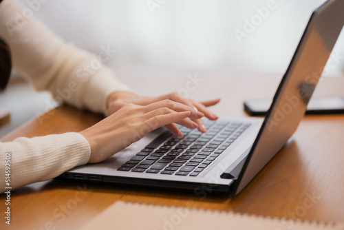 Close up hand.Asian girl using computer laptop playing game and social media or chatting with her friends.