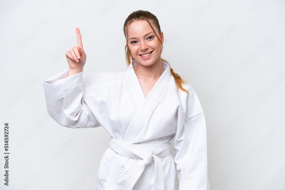 Young caucasian girl doing karate isolated on white background pointing up a great idea Young caucasian girl doing karate isolated on white background pointing up a great idea
