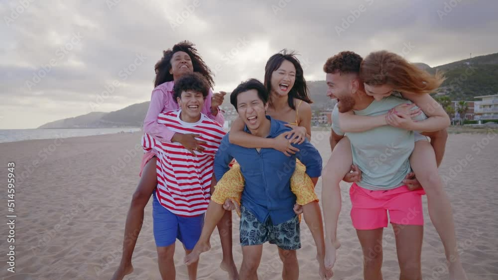 Group of friends having fun on the beach. Multiethnic Teenagers having a good time during the summer celebrating together next to the ocean. Group of friends having fun on the beach. Multiethnic Teenagers having a good time during the summer celebrating together next to the ocean.