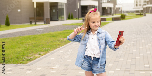 children are bloggers, a little girl records a selfie video,communicates on social networks with subscribers