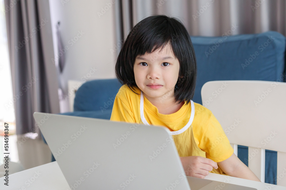 little asian girl student study online using laptop computer at home little asian girl student study online using laptop computer at home