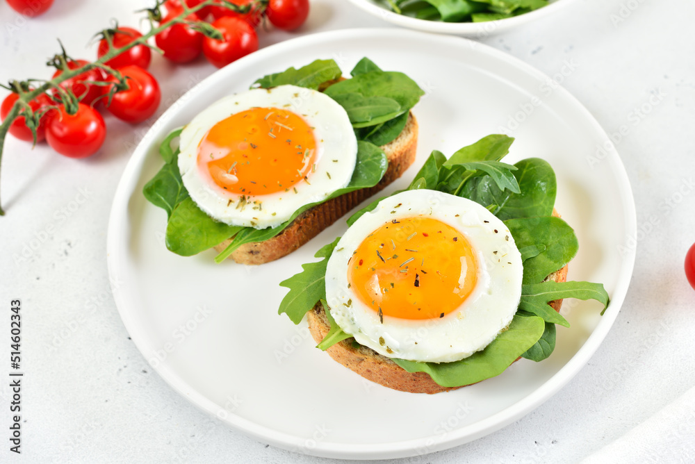 Fried eggs and greens on bread Fried eggs and greens on bread