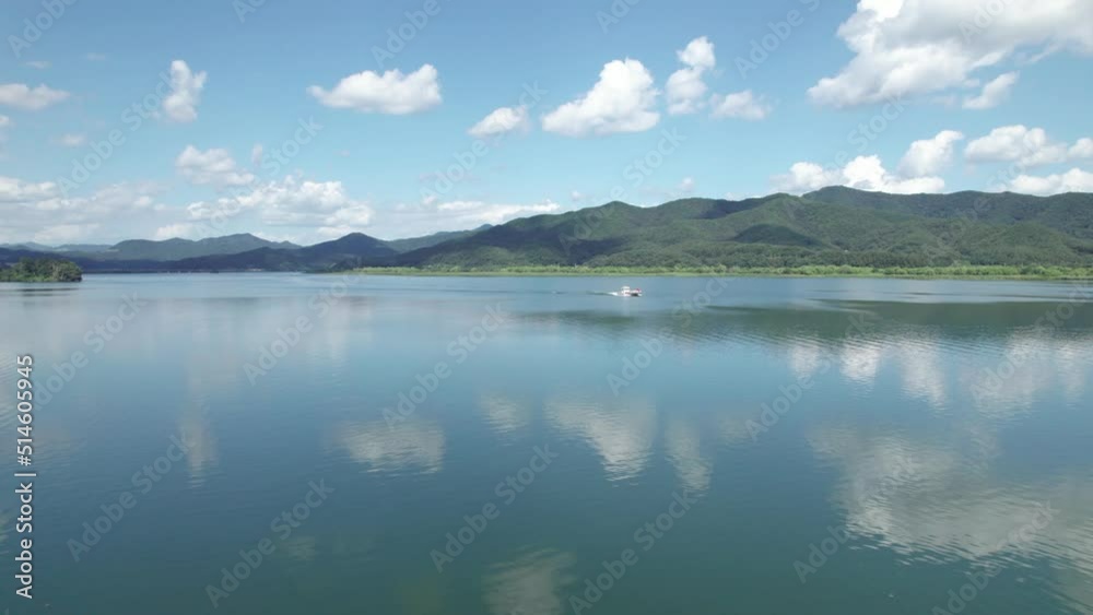 Aerial Drone of Reflective River and Boat With Mountains and Clouds in Korea Aerial Drone of Reflective River and Boat With Mountains and Clouds in Korea