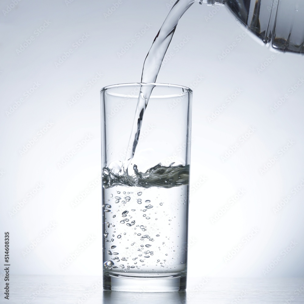 Image of pouring water from a water bottle into a glass Image of pouring water from a water bottle into a glass