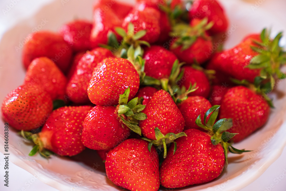 ripe and fresh strawberries in a white plate. healthy and delicious dessert. natural farm products. seasonal berry. ripe and fresh strawberries in a white plate. healthy and delicious dessert. natural farm products. seasonal berry.