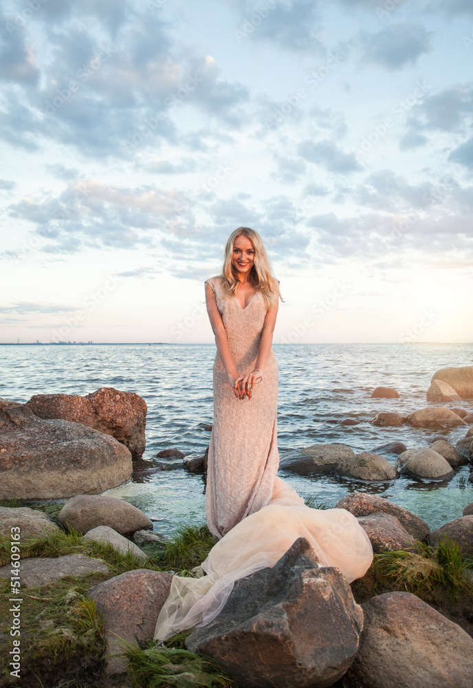 Perfect woman against summer sunset sky and clouds Perfect woman against summer sunset sky and clouds