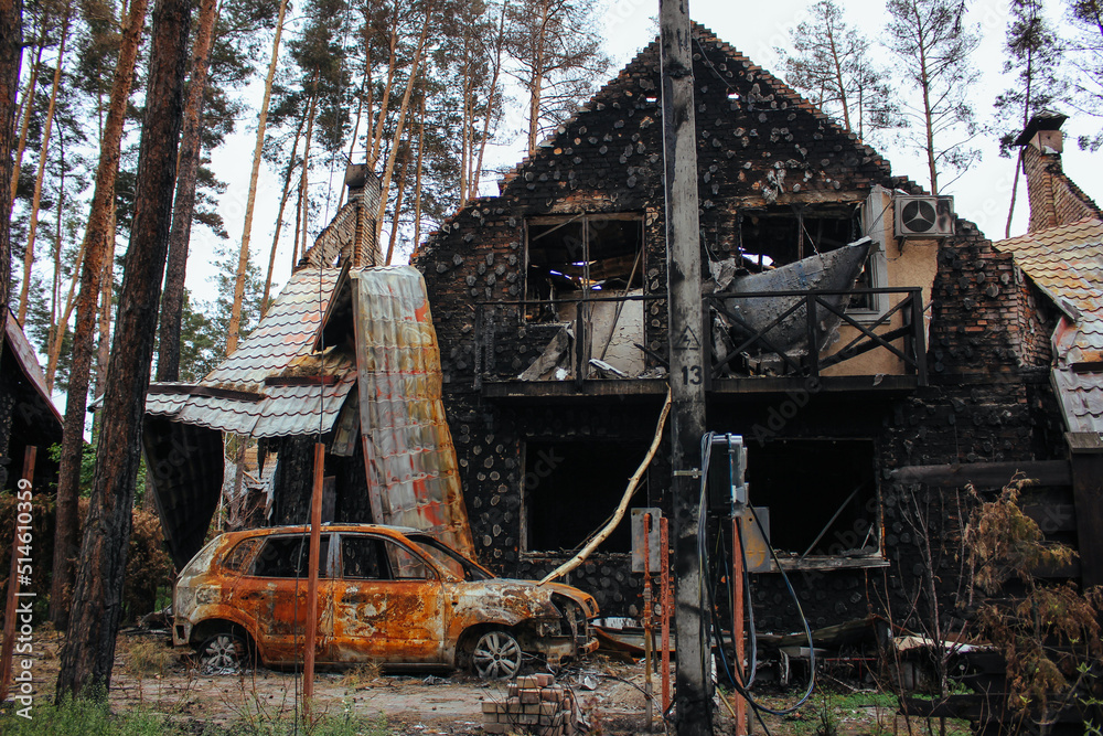Irpin, Kyiv Oblast, Ukraine: Atrocities of the Russian army in the suburbs of Kyiv. Irpin. Destroyed car near house of civilians destroyed by russian tanks. Russia's war against Ukraine.