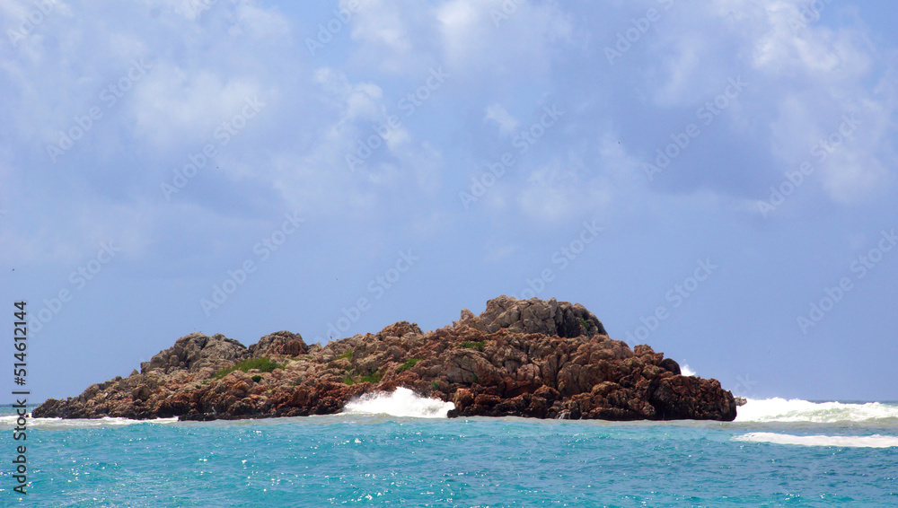 red rocky island against a completely blue background of the sea and the sky in Montenegro