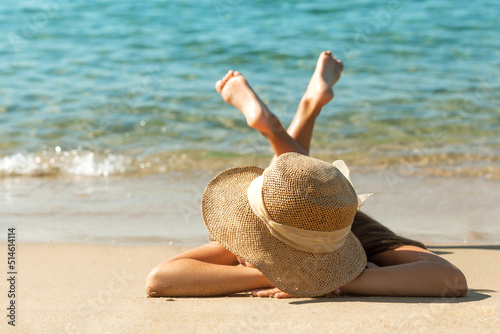 Sea Holiday on Sandy Beach Sea coast. Girl in sun hat sunbathing on tropical beach. Blue Sea Background