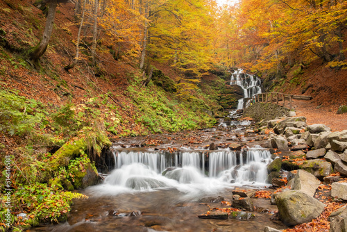 Fototapeta Naklejka Na Ścianę i Meble -  Amazing Waterfall view in autumn forest. The autumn colors surrounding the waterfall Guk in Ukraine