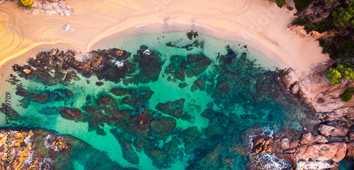 Panoramic aerial view of a paradisiacal beach. Beach vacations tourism background. Beach with transparent turquoise blue water.