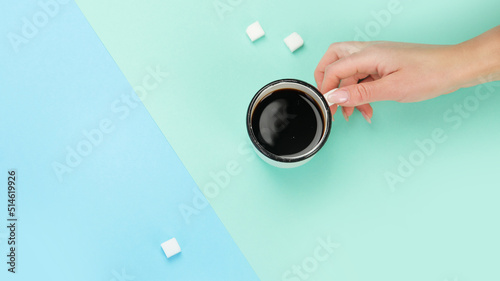Cup of coffee on color background.