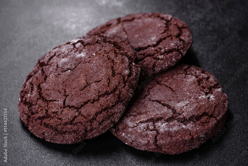 Delicious fresh chocolate biscuits on a dark concrete background with Christmas toys Delicious fresh chocolate biscuits on a dark concrete background with Christmas toys