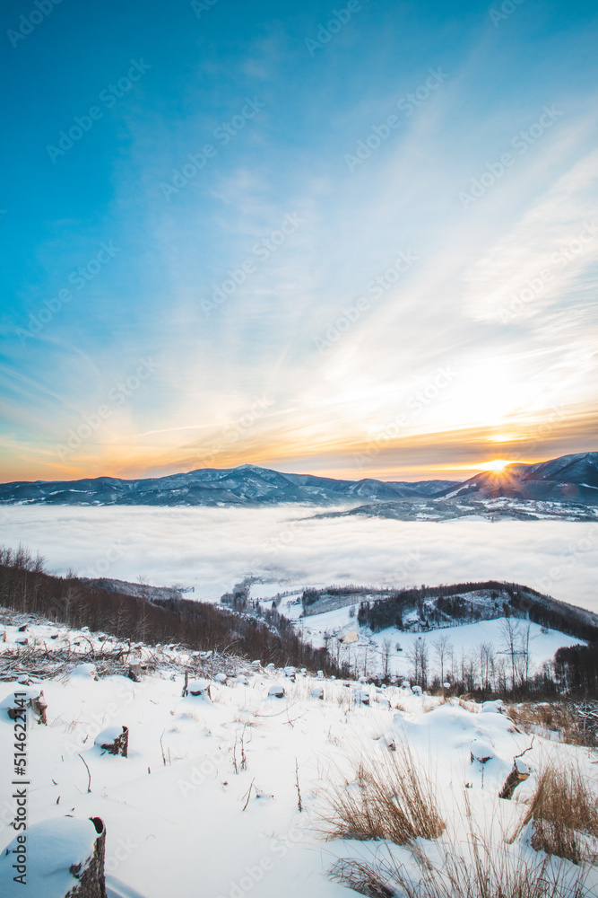 Frosty morning on Skalka mountain in Beskydy mountains overlooking the valley covered with clouds and fog and a view of Lysa mountain. Snowy landscapes. Czech republic in centre of Europe