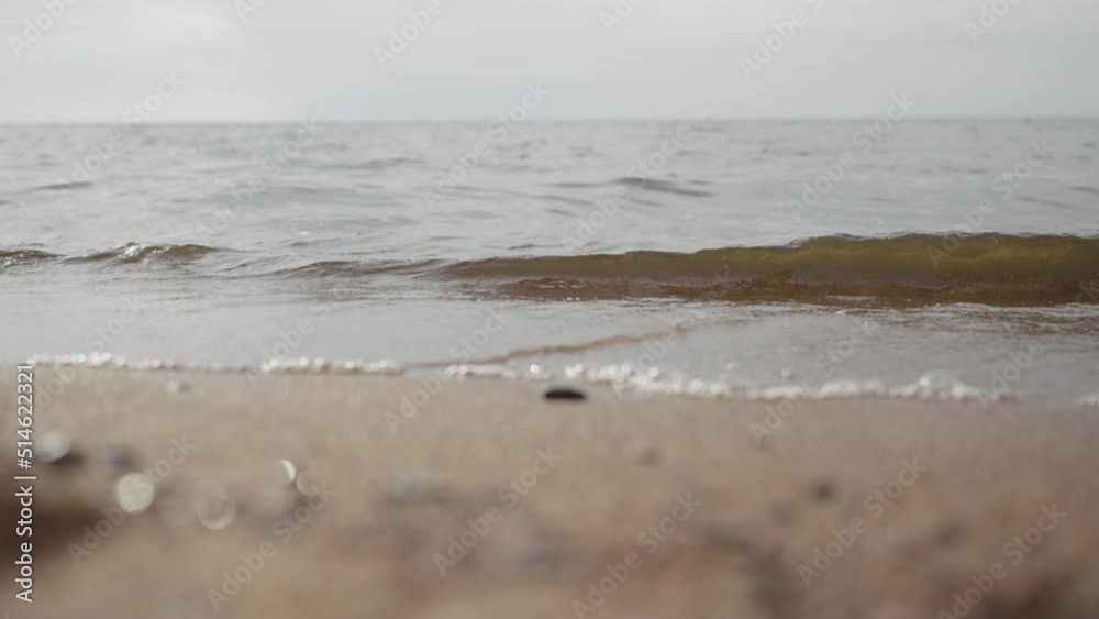 Slow motion closeup shot of waves rolling on a beach on Baltic Sea Slow motion closeup shot of waves rolling on a beach on Baltic Sea
