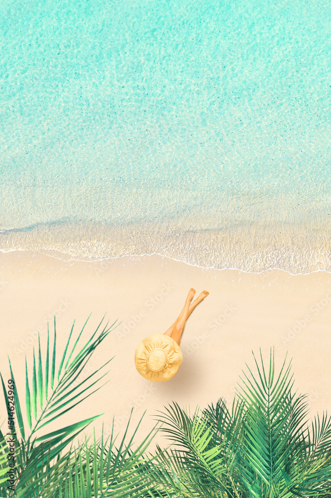 Obraz premium Top view of woman in bikini and straw hat lying and sunbathes on tropical Seychelles sea sand beach with palm tree grove. Aerial, drone view. Vertical