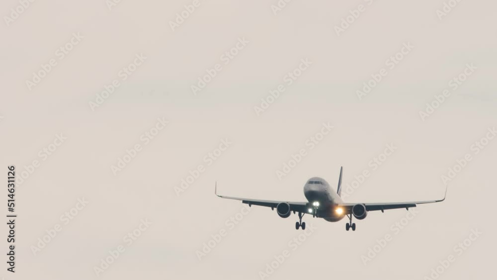 Jet aircraft landing gear release and prepared for landing. Silhouette of a commercial airplane flying in the sky