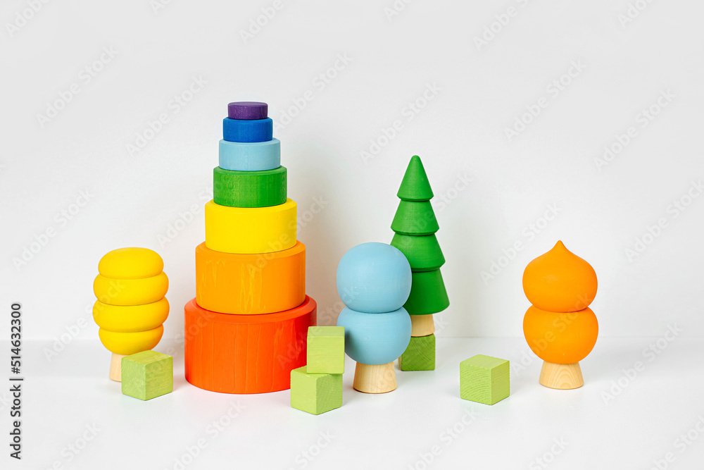Colorful wooden toys. Houses and trees in the colors of the rainbow. Games for learning and development of the child and for decorating children's room. Colorful wooden toys. Houses and trees in the colors of the rainbow. Games for learning and development of the child and for decorating children's room.