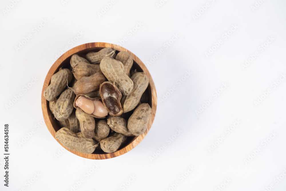 selective focus on boiled peanuts on wooden bowl isolated on white background selective focus on boiled peanuts on wooden bowl isolated on white background