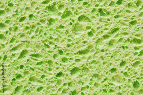 Green color porous cleaning sponge texture as background