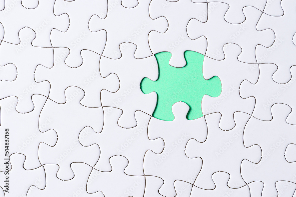 Piece of jigsaw puzzle on green paper. Flat lay, Directly above. Piece of jigsaw puzzle on green paper. Flat lay, Directly above.