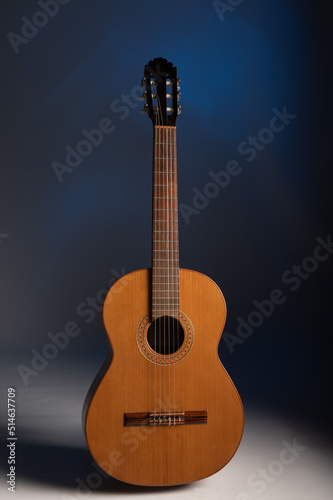 Classical guitar on a gelled blue background with space for copy