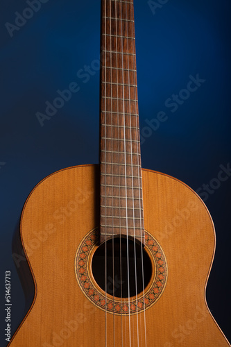 Classical guitar close up on a blue gelled background with copy space 