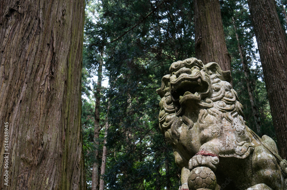 A powerful stone statue of the guardian deity of Murou Ryuketsu Shrine in Nara, Japan A powerful stone statue of the guardian deity of Murou Ryuketsu Shrine in Nara, Japan