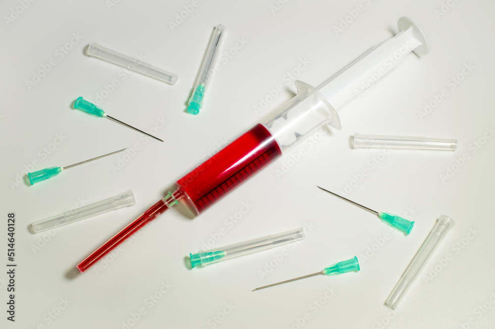 Medical syringe and needles compilation on a white background. Social problems. Vaccine against corona virus and monkeypox. Drugs and medical treatment. Blood testing in laboratory. Medical syringe and needles compilation on a white background. Social problems. Vaccine against corona virus and monkeypox. Drugs and medical treatment. Blood testing in laboratory.