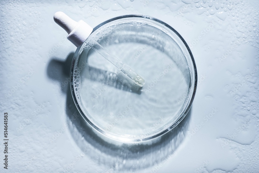 Blue cosmetic liquid on Petri dish with pipette. Tonic or toner serum gel swath. Mock up Blue cosmetic liquid on Petri dish with pipette. Tonic or toner serum gel swath. Mock up