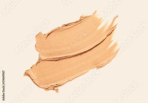 Foundation or bb cc cream and matte concealer texture swatch on beige background photo