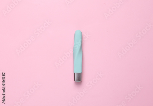 Blue clitoral vibrator on a pink background. Minimal sex still life