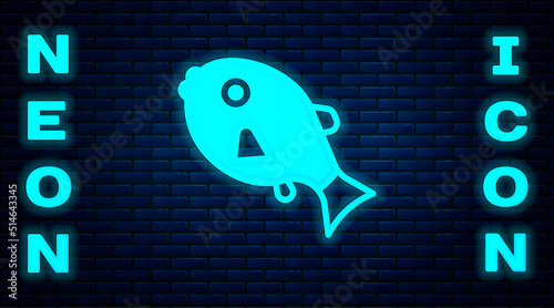 Glowing neon Tropical fish icon isolated on brick wall background. Exotic fish. Vector