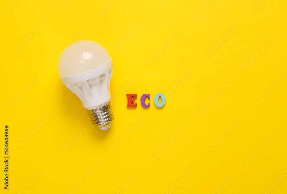 Eco concept. Led light bulb with word eco on yellow background. Top view Eco concept. Led light bulb with word eco on yellow background. Top view
