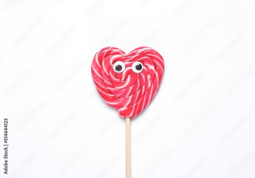 Minimal food conceptual pop still life. Heart shaped lollipop with goggles on white background Minimal food conceptual pop still life. Heart shaped lollipop with goggles on white background