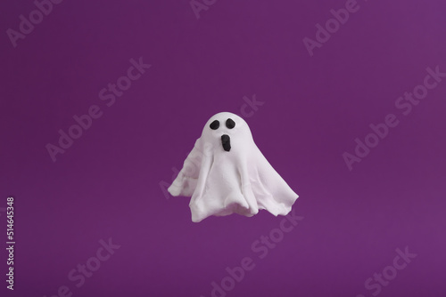 Hand made plasticine ghost on purple background. Halloween concept. Trick or Treat
