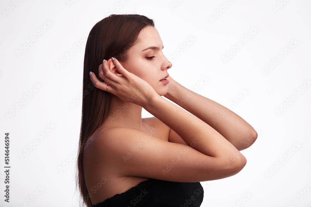 Pretty young fitness woman with straight hair in black sleeveless top sportswear on white background. Casual look