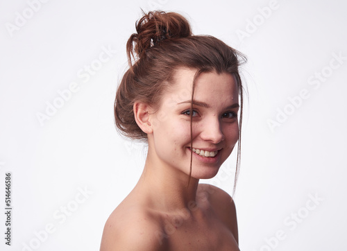Young woman problem skin. Acne, pimple, clear and clean, oily, dry skin concept. Cose up of worried young lady touching her face gently on white background